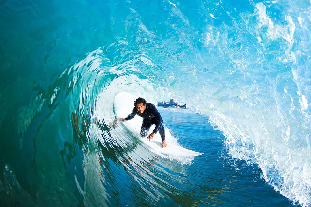 surfer surfing through a wave